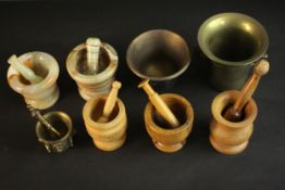 A collection of six pestle and mortars. Two brass mortars without pestles. Materials include