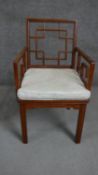 A Chinese hardwood open armchair with a square cockpen style back over a loose seat cushion.