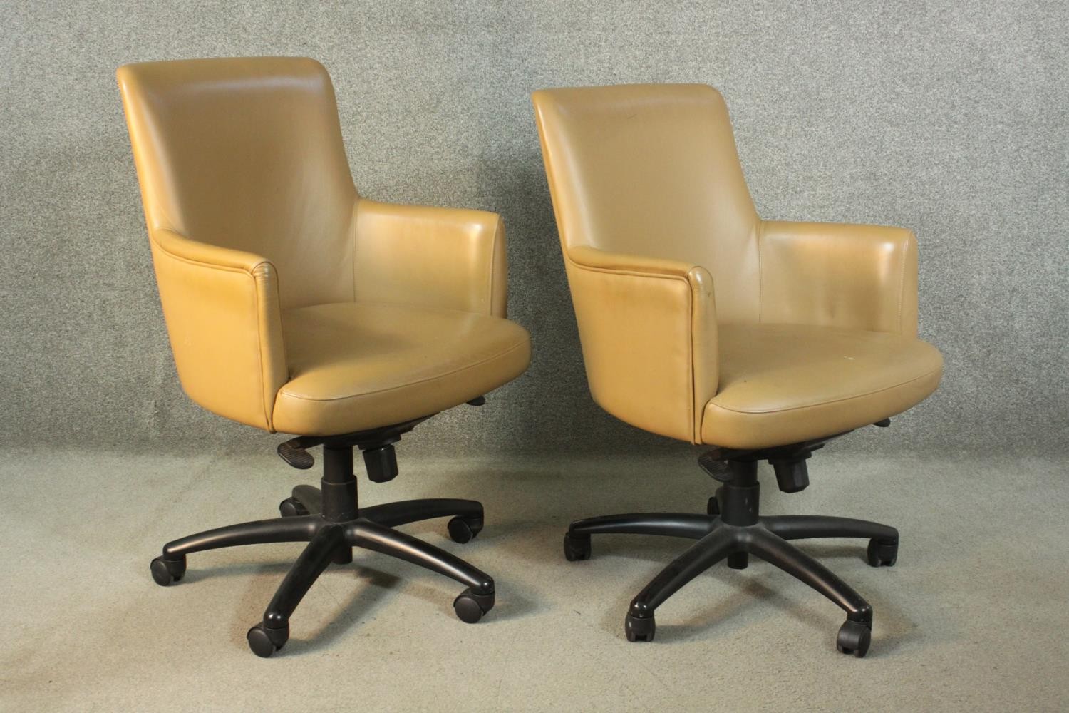 A pair of late 20th century tan leather swivel office chairs, of tub form, with a five point base on - Image 5 of 9