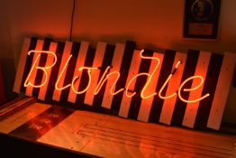 Pop Memorabila: Original neon Blondie sign mounted on black and white parallel wooden boards. Used