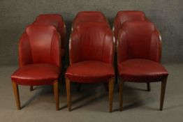 A set of six Art Deco walnut cloud back dining chairs in faux leather upholstery on tapering