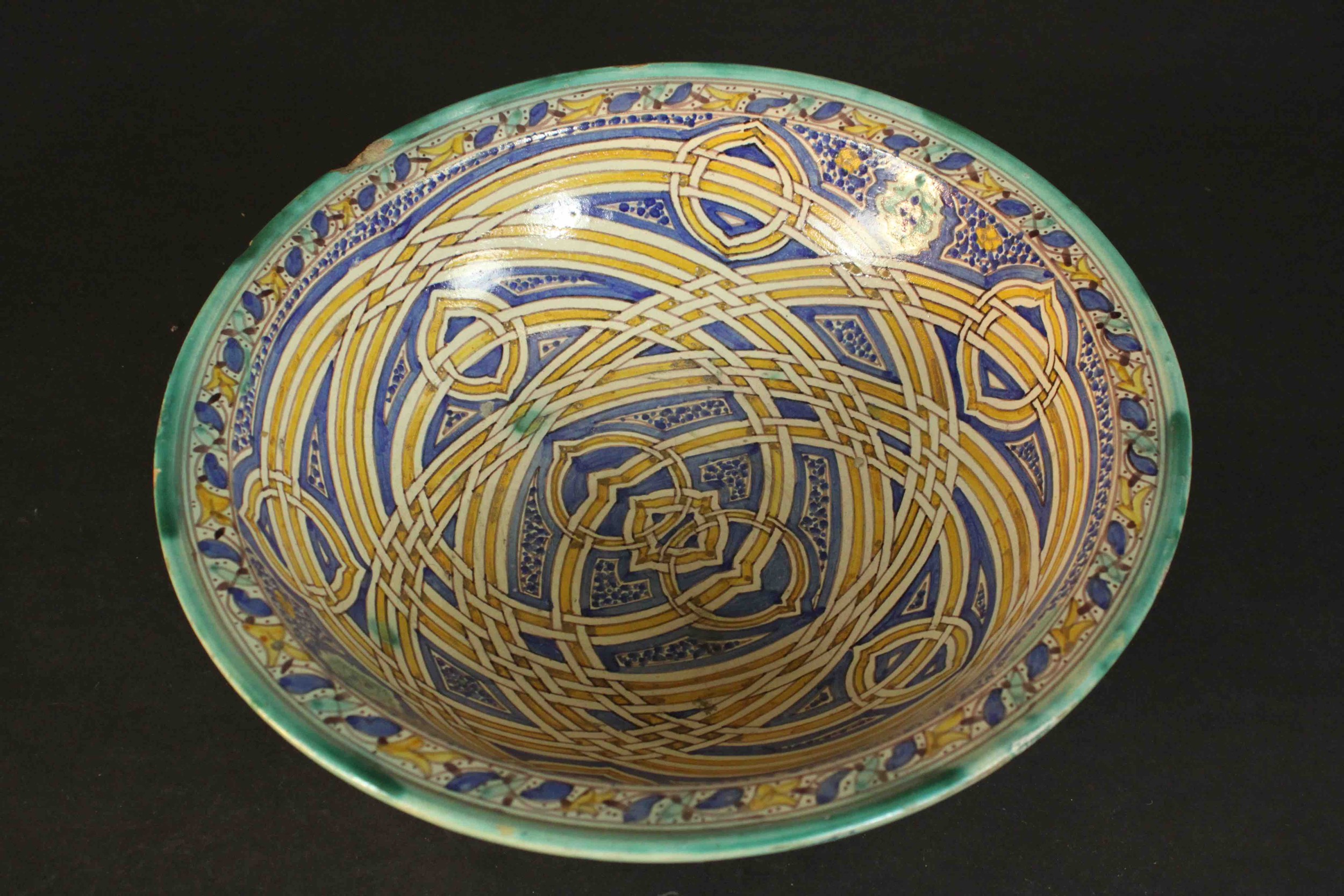 A large early 20th century Moroccan interlocking ring pattern hand painted ceramic bowl. H.13 Dia.