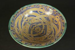 A large early 20th century Moroccan interlocking ring pattern hand painted ceramic bowl. H.13 Dia.