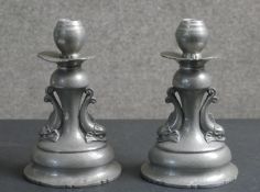 A pair of early 20th century Danish Gerotin dolphin design hammered pewter candle sticks. Maker's