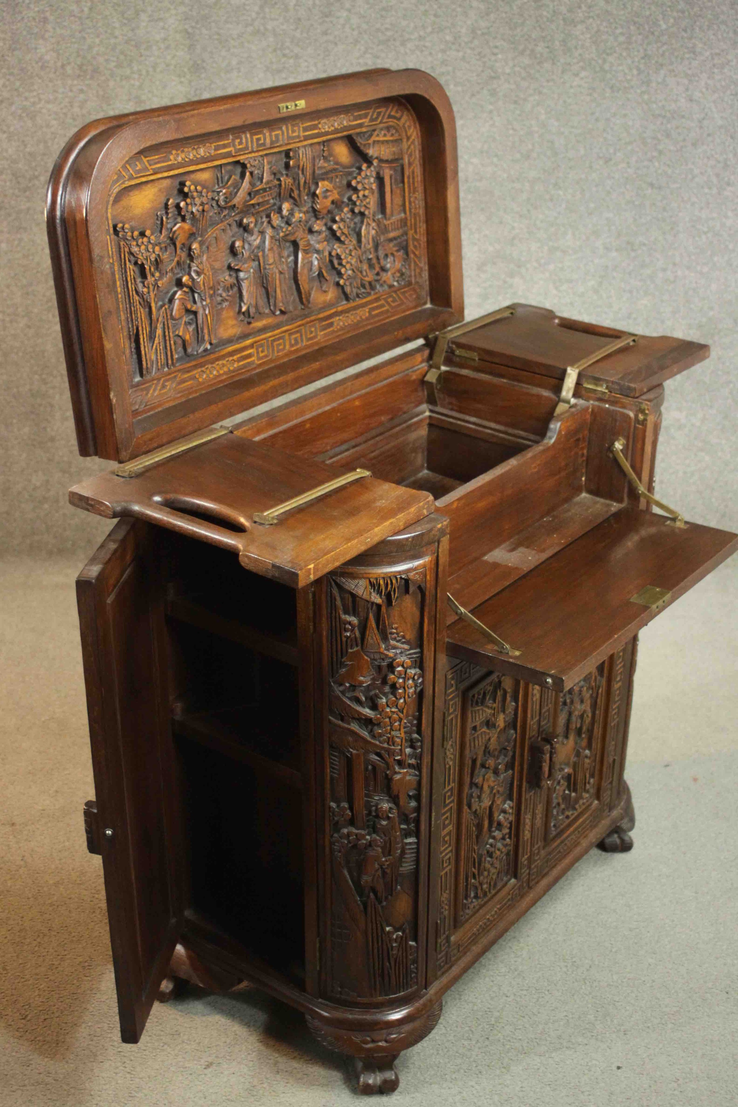An early 20th century Chinese carved hardwood cabinet with central fitted drinks section. H.87 W. - Image 10 of 14