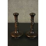 A pair of Japanese Meji period bronze gourd form candlesticks. Each with a relief dragon wrapped