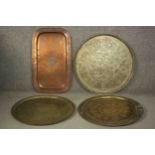 A collection of four 19th century Oriental brass and copper trays. Three circular trays
