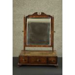 A 19th century mahogany dressing table mirror with bevelled swing plate above base fitted with