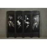 A small 20th century Japanese four panel carved and lacquered folding screen mounted on board.