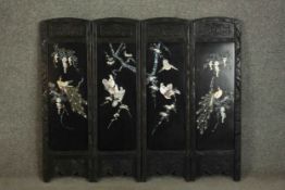 A small 20th century Japanese four panel carved and lacquered folding screen mounted on board.