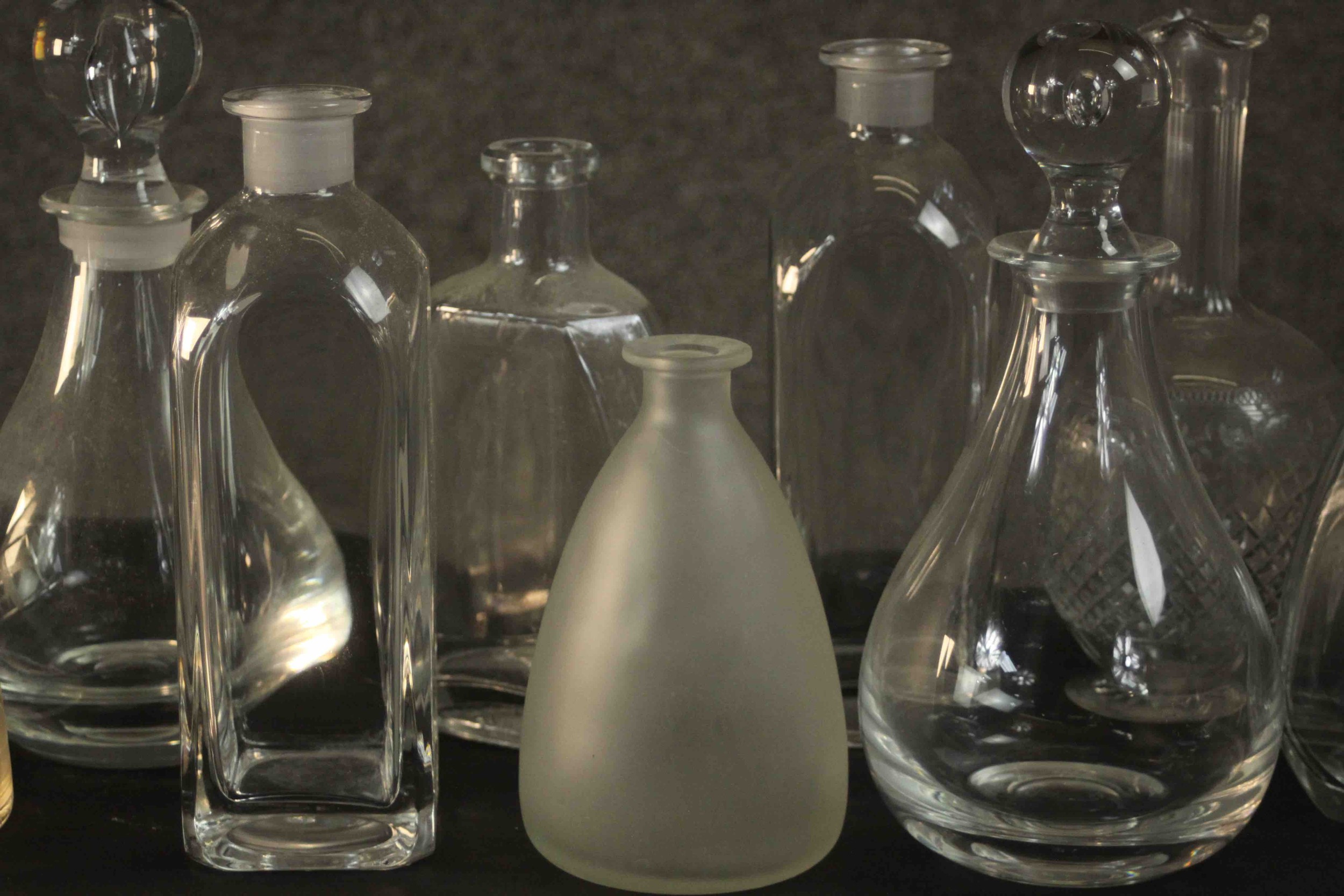 A collection of nine glass decanters, two clear crystal with blown glass stoppers. H.26 Dia.12cm. ( - Image 7 of 8