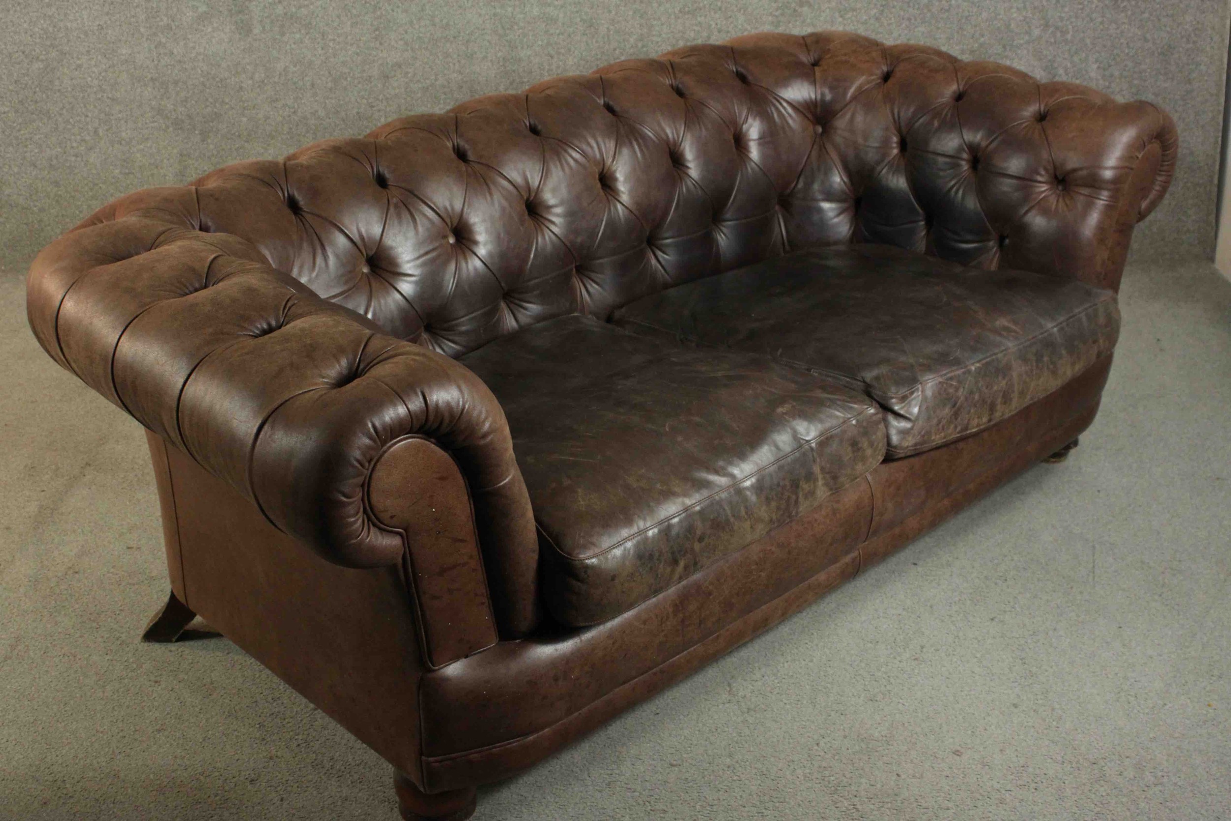 A contemporary brown leather Chesterfield sofa, with buttoned scrolling arms and back, on turned - Image 9 of 11