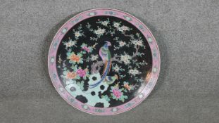 A large early 20th century Chinese Famille Rose hand painted ceramic charger with pheasant in a tree
