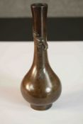 A Chinese 19th century bronze gourd shaped vase with relief lucky bat and engraved double