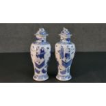 A pair of 19th century Chinese blue and white hand painted porcelain vases and covers. The lidded