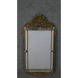 A 19th century carved giltwood and gesso pier mirror with shell cresting above cushion style
