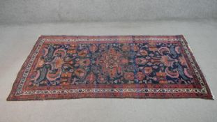 A hand woven Persian Hamadan rug with all over foliate motifs across the deep blue ground. L.190 W.