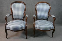 A pair of 19th century Louis XV style mahogany framed open armchairs with upholstered backs, arms