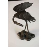 A Japanese Meiji period cast bronze figural study of crane on a naturalistic base with a tortoise at