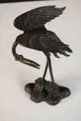 A Japanese Meiji period cast bronze figural study of crane on a naturalistic base with a tortoise at