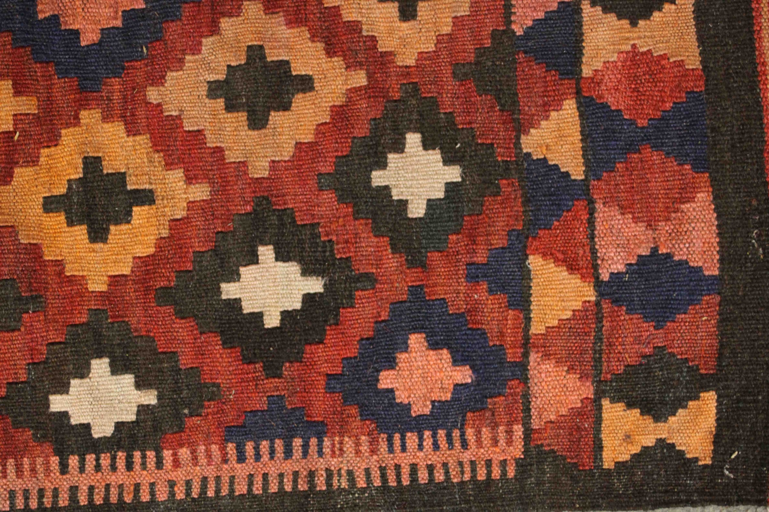 An Afghan Kelim rug with repeating diamond motif on a terracotta ground. L.94 W.69cm. - Image 4 of 5