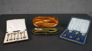 A collection of silver spoons, including two boxed sets of six silver coffee spoons with coffee bean