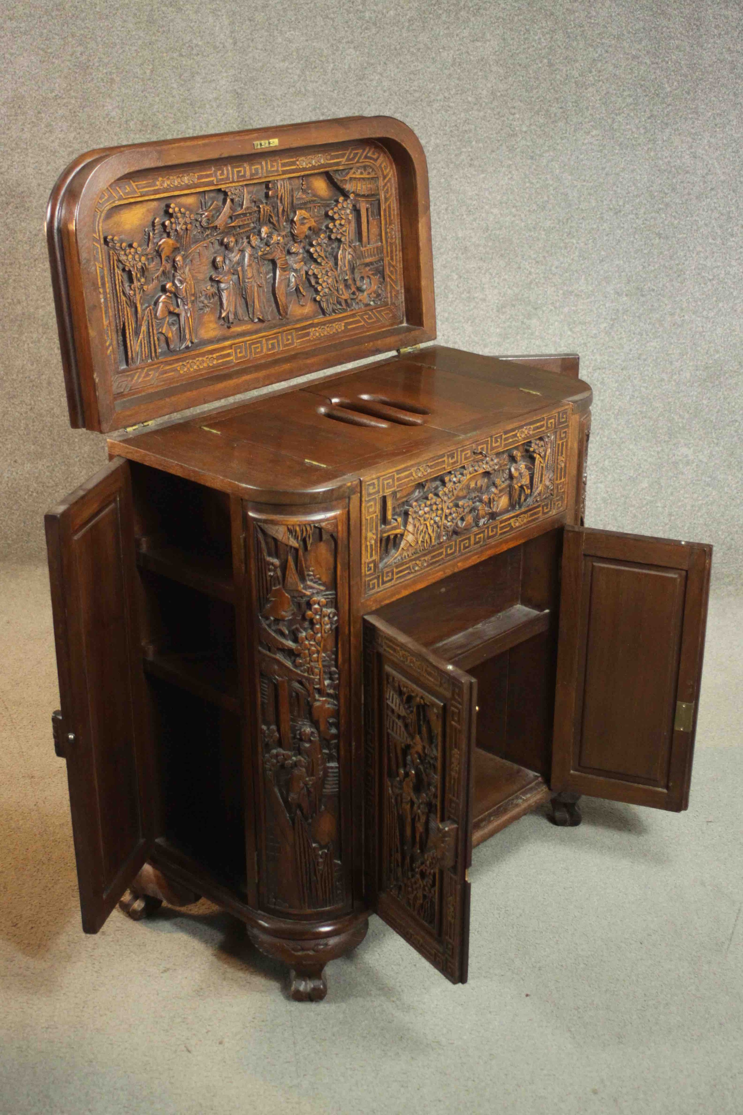 An early 20th century Chinese carved hardwood cabinet with central fitted drinks section. H.87 W. - Image 11 of 14