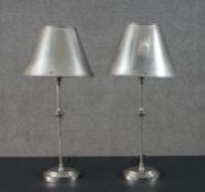 A pair of 20th century chrome table lamps with aluminium shades. H.53cm