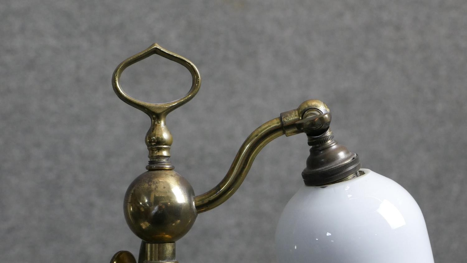 An early 20th century brass student's lamp with handle on a moulded circular base. The bell form - Image 4 of 6
