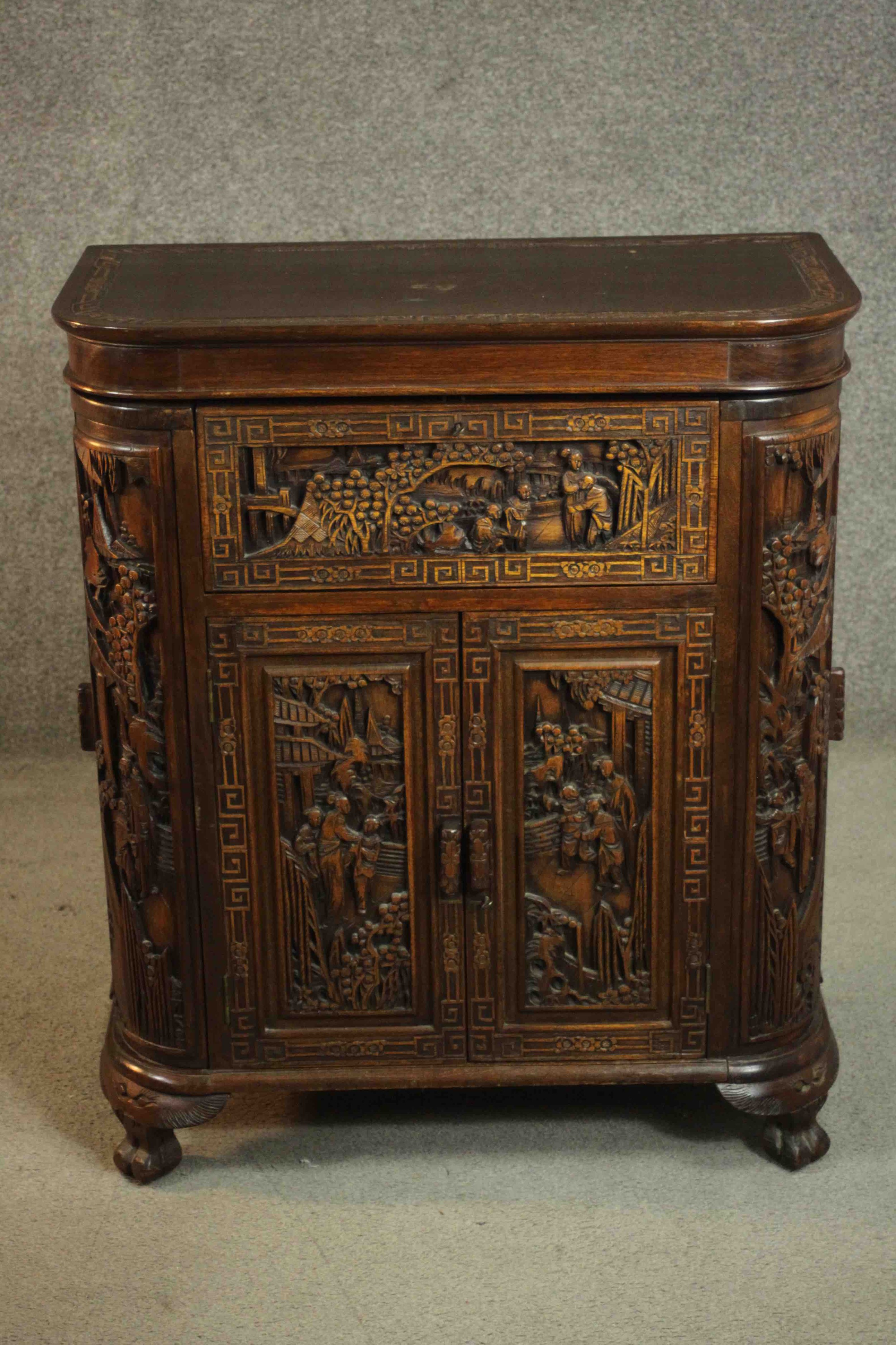 An early 20th century Chinese carved hardwood cabinet with central fitted drinks section. H.87 W. - Image 3 of 14