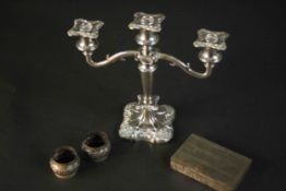 A silver plated three branch candelabra with vine design along with two repousse silver plated