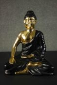 A large ceramic black and gold Buddha figure. H.45 W.35 D.21cm.