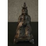 A 19th century Chinese bronze figure of a Chinese seated deity in traditional robes. H.27 W.14 D.