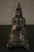 A 19th century Chinese bronze figure of a Chinese seated deity in traditional robes. H.27 W.14 D.