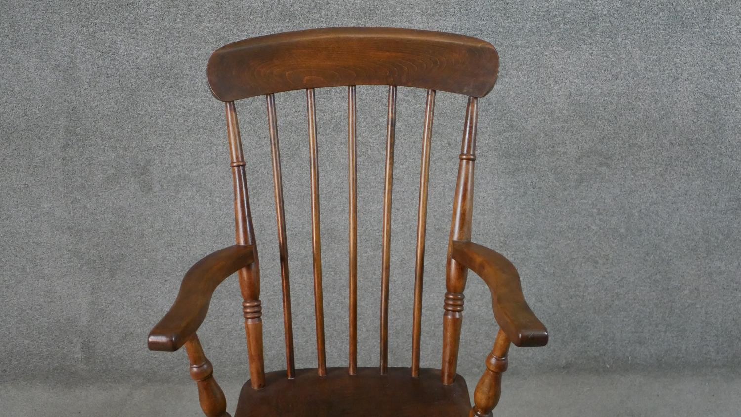 A 19th century style comb back rocking chair, with an elm seat, on turned legs joined by stretchers. - Image 4 of 4
