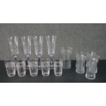 A collection of etched drinking glasses, including a set of four hand cut floral design champagne