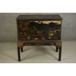 An early 19th century chest on stand with all over hand decorated black lacquered Chinoiserie