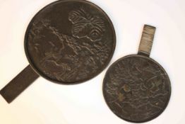 Two Japanese Meji period bronze hand mirrors, each circular plaque cast in relief with cranes