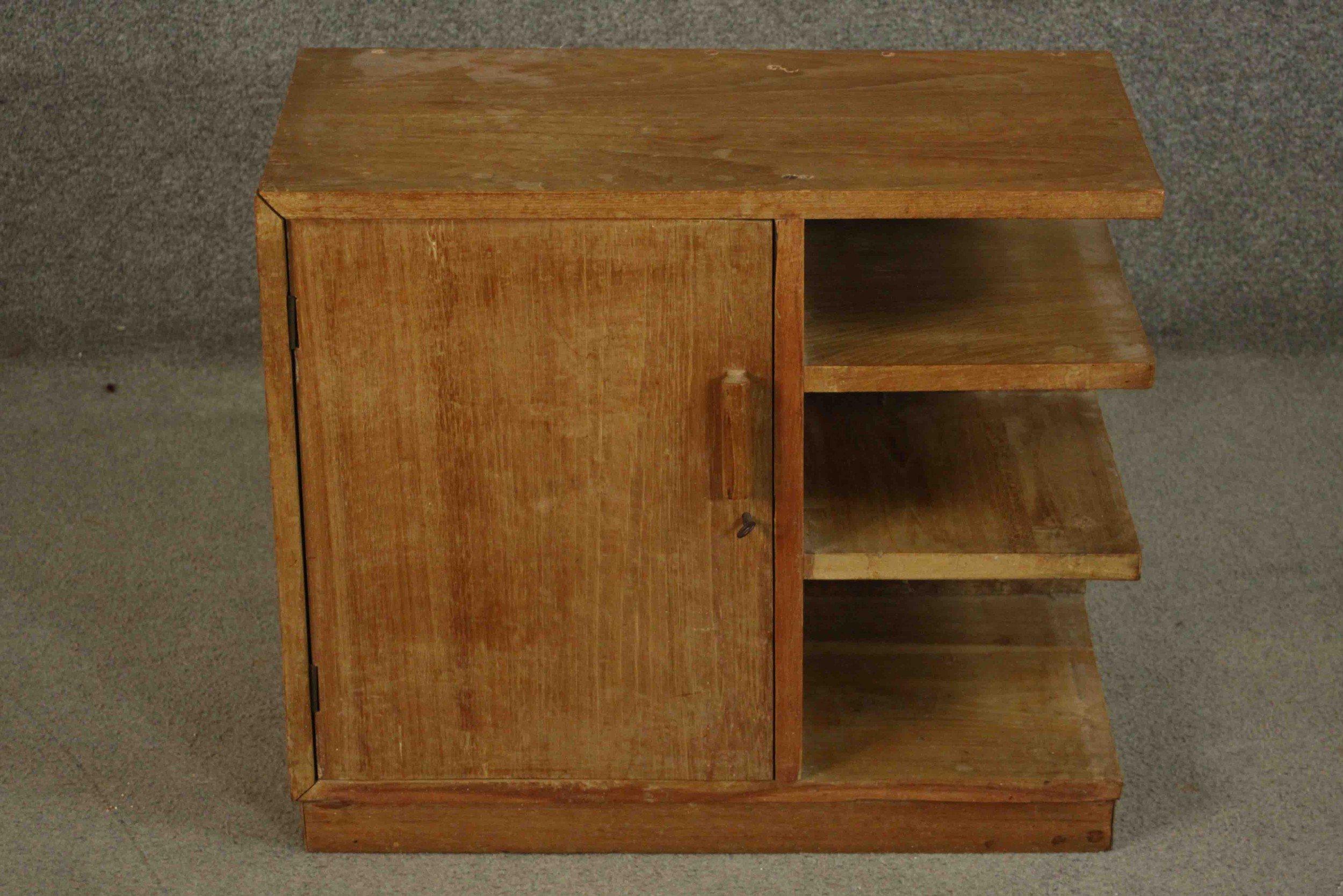 A mid century side cabinet fitted with panel door and open shelves. H.33 W.61 D.29cm.