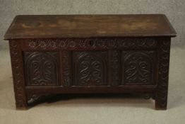 An 18th century carved oak panelled coffer on stile supports, with it's original hinges. H.54 W.