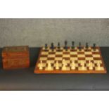 A marquetry chess board and carved chess set. H.42 W.42cm.(Board)