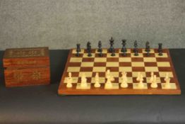 A marquetry chess board and carved chess set. H.42 W.42cm.(Board)