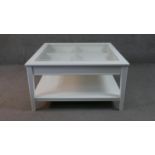 A contemporary vitrine style coffee table with fitted drawer and undertier. H.50 W.93 D.93cm