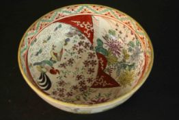 A Japanese 19th century satsuma ware hand painted bowl decorated with flowers and roosters.