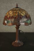 A Tiffany style table lamp, with a stained glass shade on a bronzed base. H.45 Dia.30cm.