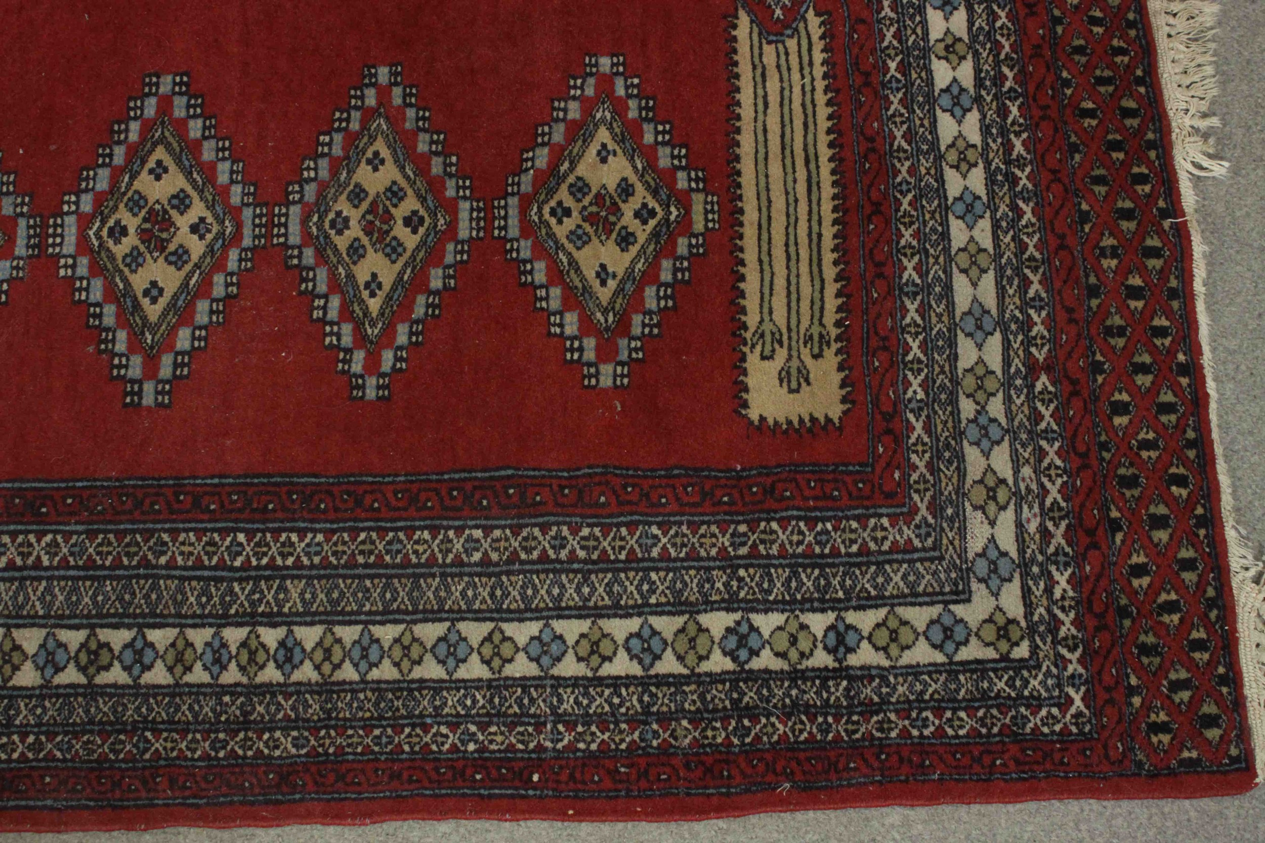 A Pakistan Bokhara with repeating diamond motifs on a burgundy field within stylised flowerhead - Image 5 of 6