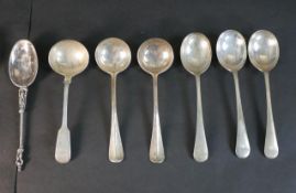A collection of seven silver spoons, including a Dutch apostle spoon, three Victorian sauce ladles