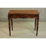 A Victorian mahogany tea table, of rectangular form with a foldover top over a shaped frieze with
