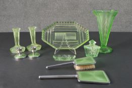 An Art Deco green glass dressing table set along with a pair of chrome and green candlesticks with