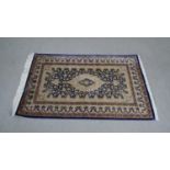 A handmade blue ground Chinese silk rug L.118 H.76cm